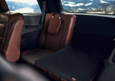 The left rear seat of a 2024 Lincoln Aviator® SUV is shown folded flat for additional cargo space | Carman Lincoln in New Castle DE