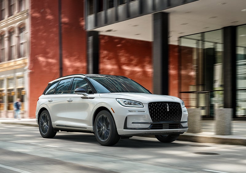 The 2024 Lincoln Corsair® SUV with the Jet Appearance Package and a Pristine White exterior is parked on a city street. | Carman Lincoln in New Castle DE