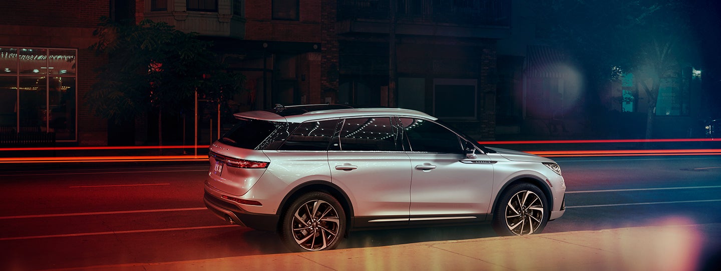 The 2024 Lincoln Corsair® SUV is parked on a city street at night. | Carman Lincoln in New Castle DE