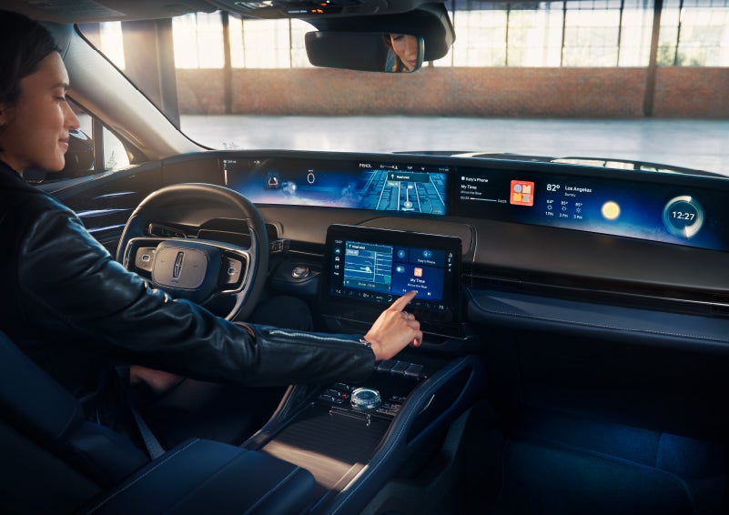 The driver of a 2024 Lincoln Nautilus® SUV interacts with the center touchscreen. | Carman Lincoln in New Castle DE