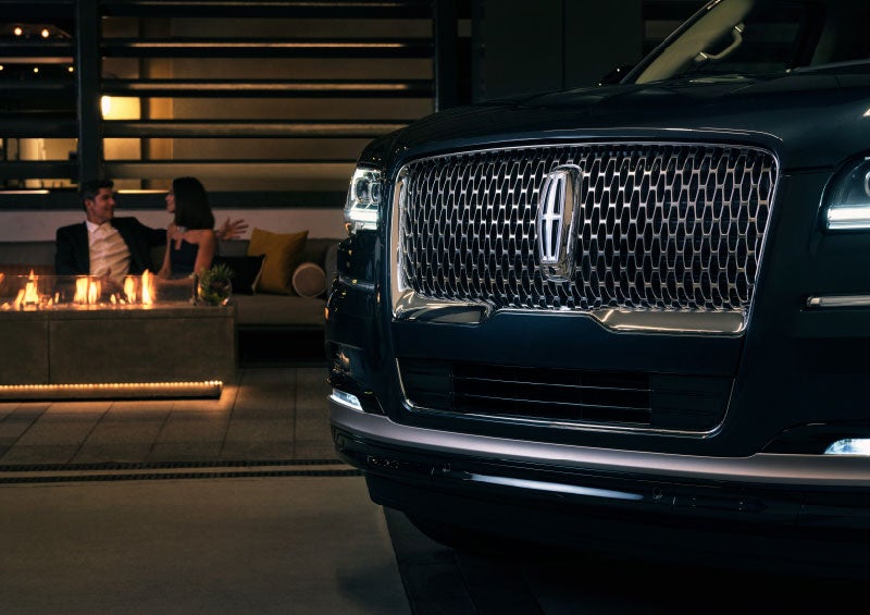 The Lincoln Star of a 2024 Lincoln Navigator® SUV is elegantly illuminated.