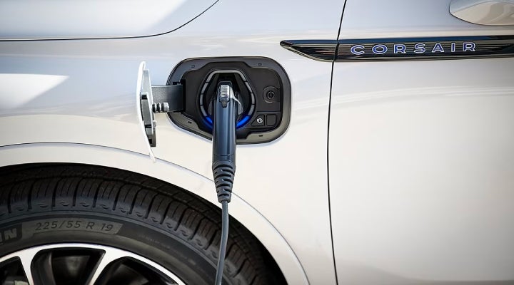 An electric charger is shown plugged into the charging port of a Lincoln Corsair® Grand Touring
model. | Carman Lincoln in New Castle DE