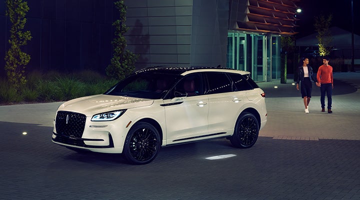 Two people approach a 2024 Lincoln Corsair® SUV featuring the available Jet Appearance Package. | Carman Lincoln in New Castle DE