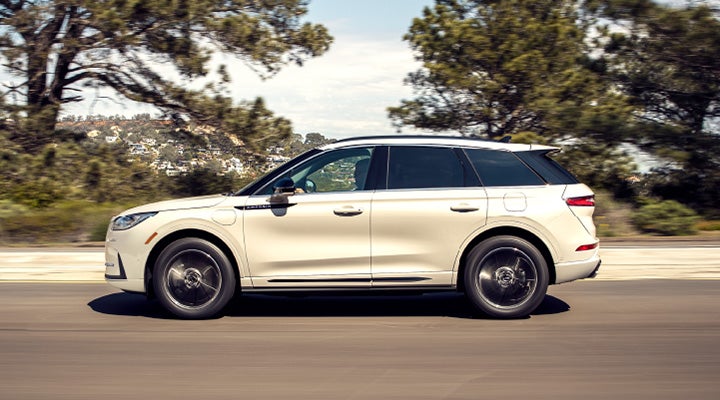 A 2025 Lincoln Corsair® Grand Touring model is being driven in the countryside.