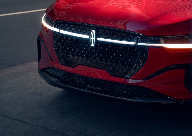 The available front LED light bar and center Lincoln Star logo glow at dusk. | Carman Lincoln in New Castle DE