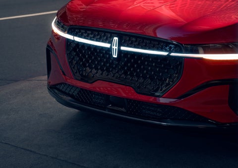 The available front LED light bar and center Lincoln Star logo glow at dusk. | Carman Lincoln in New Castle DE