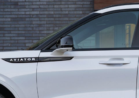 The driver’s side door and fender badging of a white 2026 Lincoln Aviator® SUV are showcased. | Carman Lincoln in New Castle DE