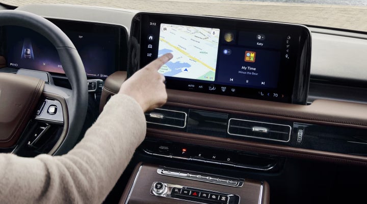 A person is tapping the center display touchscreen of a 2026 Lincoln Aviator® SUV. | Carman Lincoln in New Castle DE