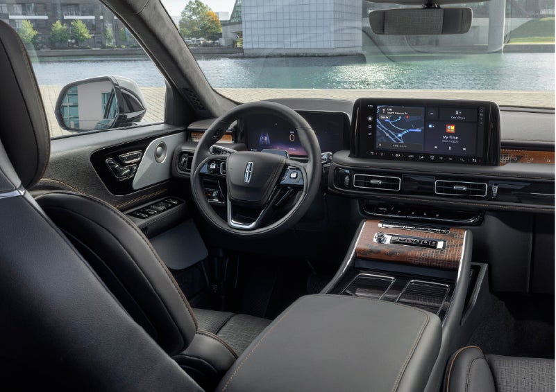 The interior of the 2026 Lincoln Aviator® SUV is shown parked with a view of a harbor through the windshield. | Carman Lincoln in New Castle DE
