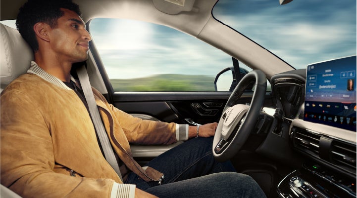 A person is shown using Lincoln BlueCruise hands-free highway driving technology on a divided highway in a hands-free Blue Zone. | Carman Lincoln in New Castle DE