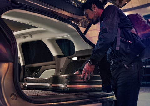 A man is shown loading cargo into the rear of a 2026 Lincoln Corsair® SUV with the second-row seats folded flat. | Carman Lincoln in New Castle DE