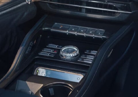 A smartphone is shown charging in the wireless charging pad. | Carman Lincoln in New Castle DE