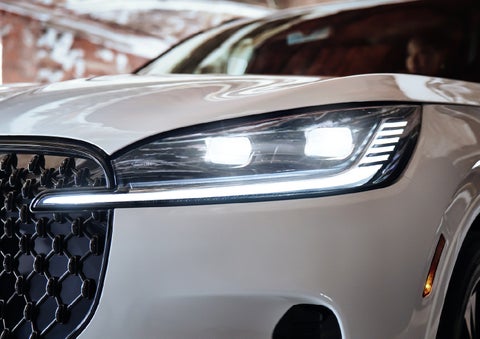A close-up of a headlamp on the 2027 Lincoln Aviator® SUV is shown. | Carman Lincoln in New Castle DE