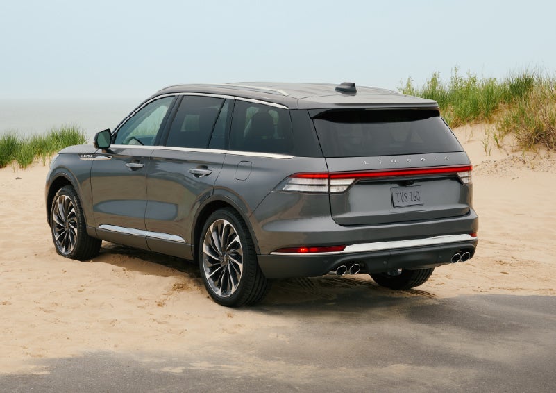 A 2027 Lincoln Aviator® SUV is parked next to sand dunes. | Carman Lincoln in New Castle DE
