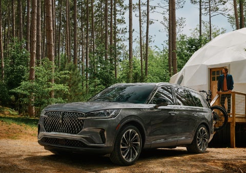 A 2027 Lincoln Aviator® is parked next to a high end glamping site. | Carman Lincoln in New Castle DE