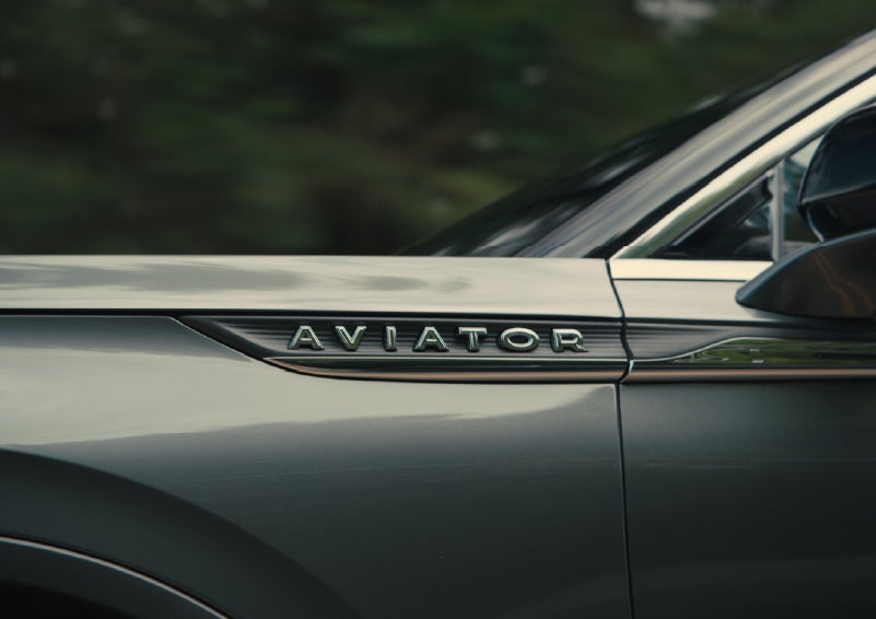The driver’s side door and fender badging of a gray 2027 Lincoln Aviator® SUV are showcased. | Carman Lincoln in New Castle DE