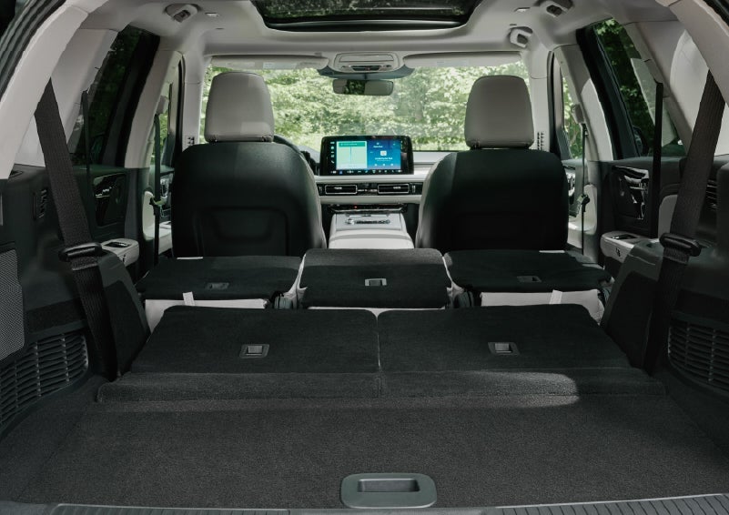 A rear to front view of the interior of a 2027 Lincoln Aviator® Black Label™ SUV shows the third and second rows folded flat | Carman Lincoln in New Castle DE