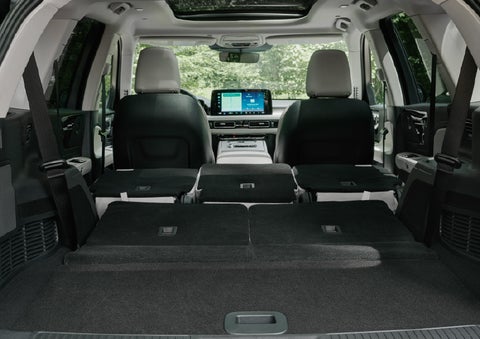 A rear to front view of the interior of a 2027 Lincoln Aviator® Black Label™ SUV shows the third and second rows folded flat | Carman Lincoln in New Castle DE