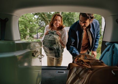 A couple loads luggage into the rear of a 2027 Lincoln Aviator® Black Label™ SUV..e 202 | Carman Lincoln in New Castle DE