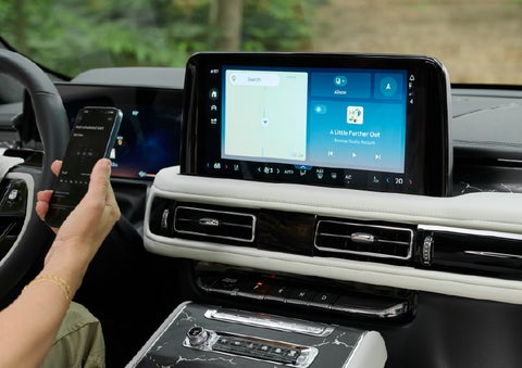 A person pairs thier phone with the center touchscreen of a 2027 Lincoln Aviator® Black Label™ SUV | Carman Lincoln in New Castle DE